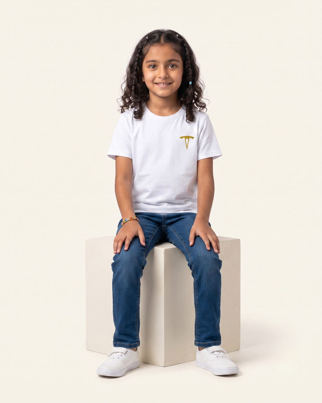 Girl sitting wearing a white OUTCAST basic tee with jeans