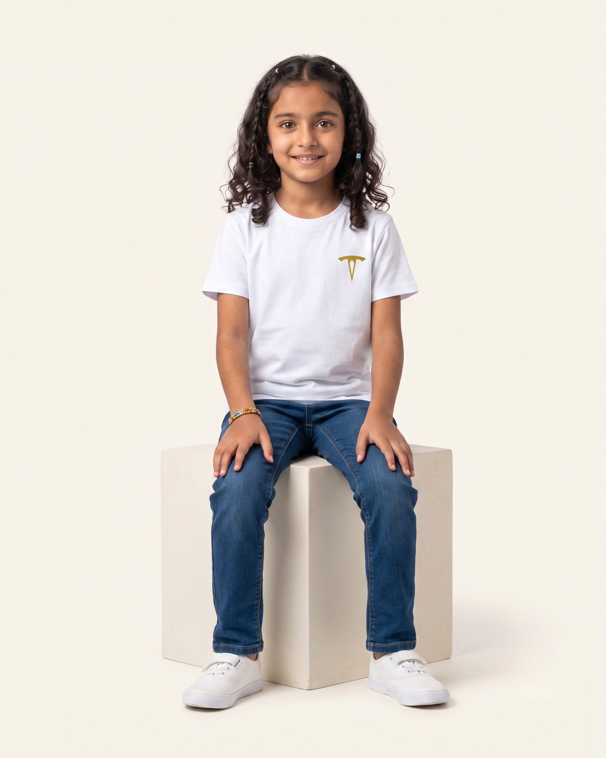 Girl sitting wearing a white OUTCAST basic tee with jeans