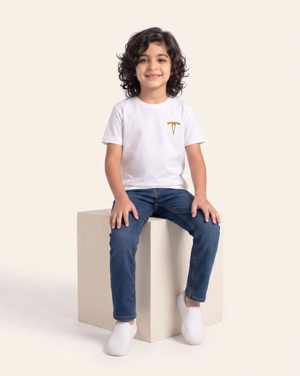Boy sitting wearing a white OUTCAST basic tee with jeans