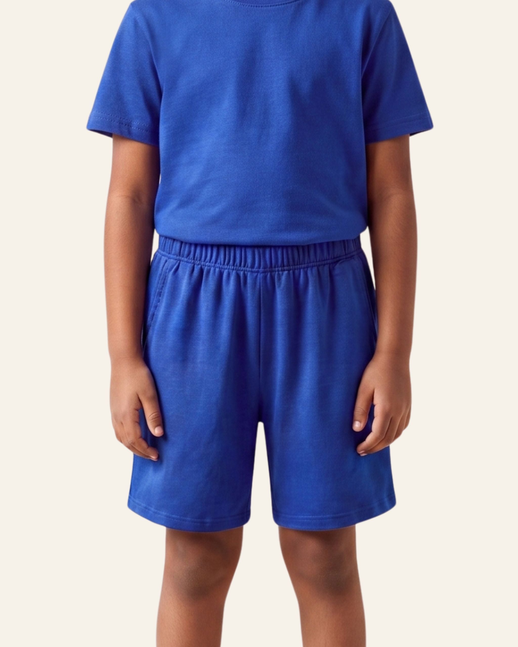 Boy wearing royal blue OUTCAST kids shorts