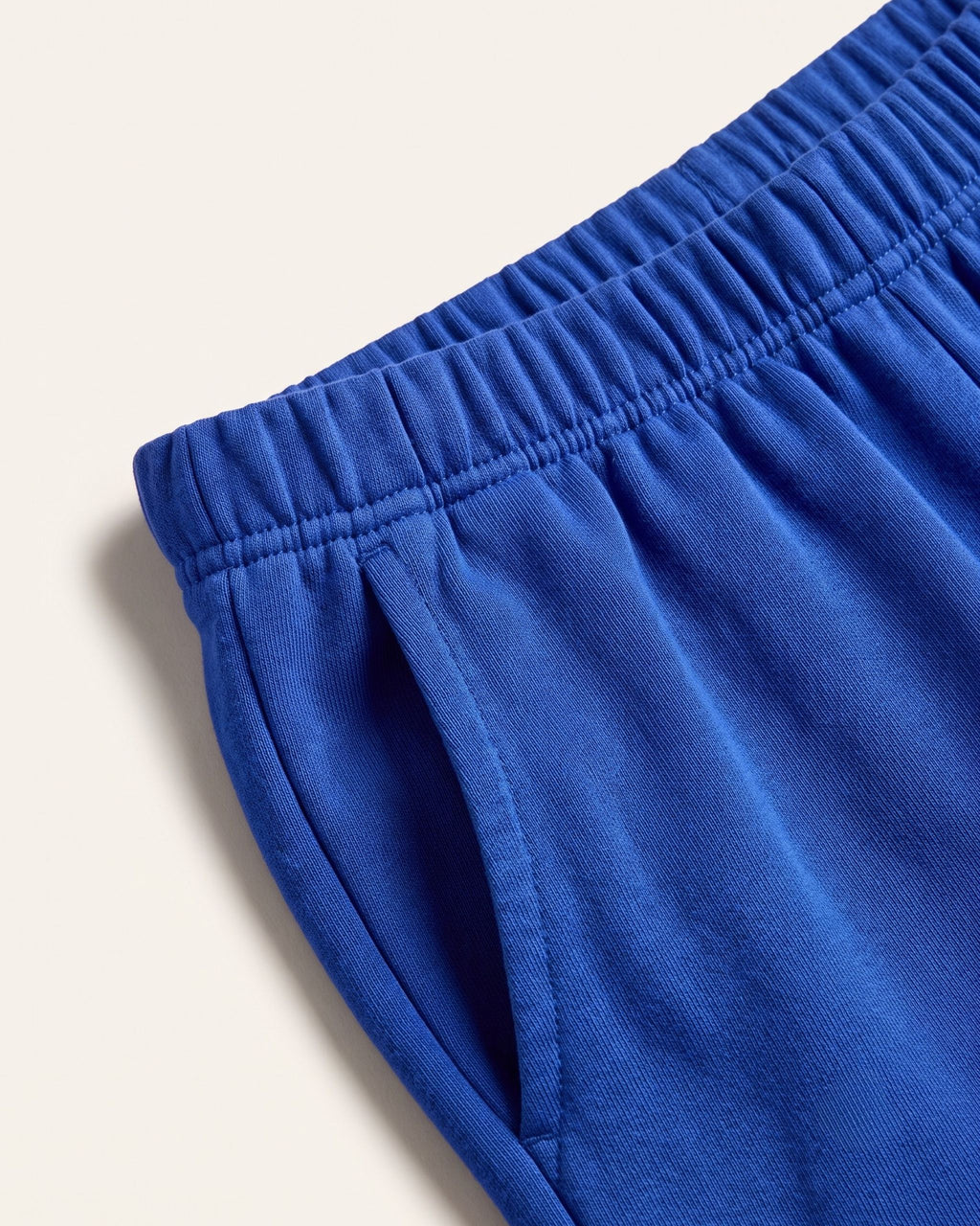 Close-up of the elastic waistband on royal blue kids shorts