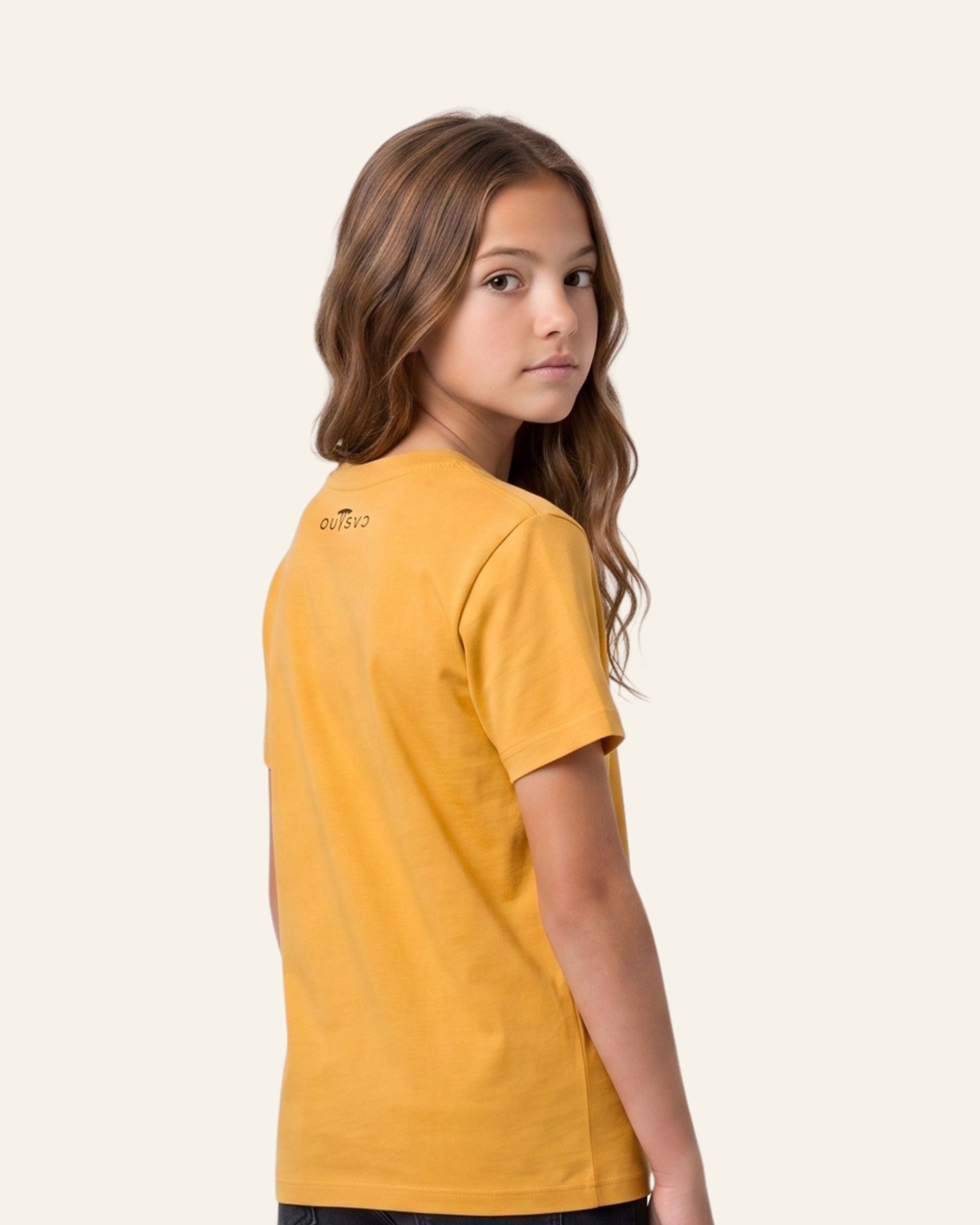Girl wearing a mustard OUTCAST basic tee, side view