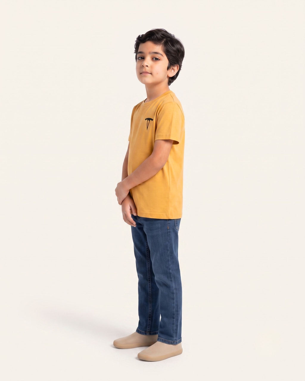 Boy wearing a mustard OUTCAST basic tee, side view