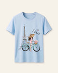 Light blue kids cotton tee with a watercolour Eiffel Tower and cyclist print