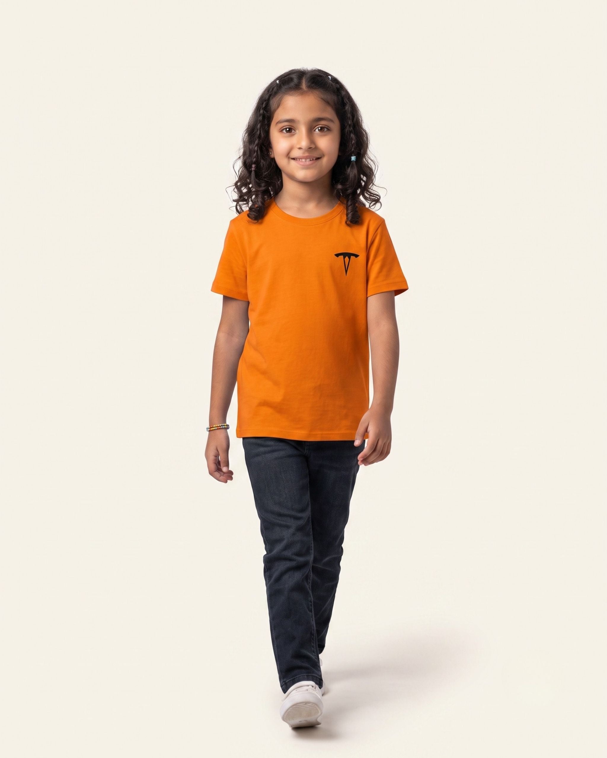 Girl wearing an orange OUTCAST basic tee with black jeans