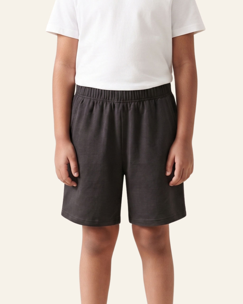 Boy wearing black OUTCAST kids shorts