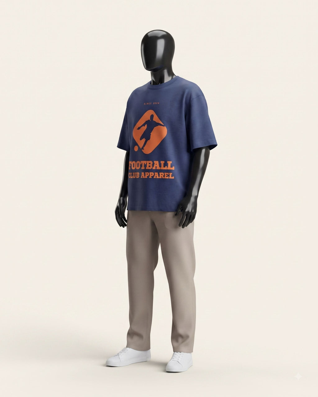 Man wearing a navy cotton tee with a bold orange football crest on the front