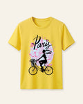 Yellow kids cotton tee with a girl cycling past a pink Eiffel Tower print
