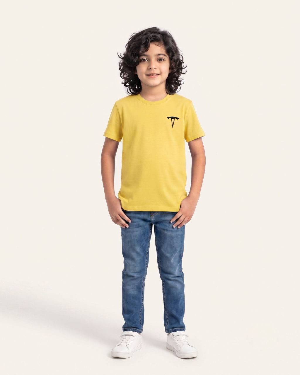 Boy wearing a yellow OUTCAST basic tee with jeans