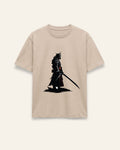 Front of the sand cotton tee with a black lone swordsman silhouette print