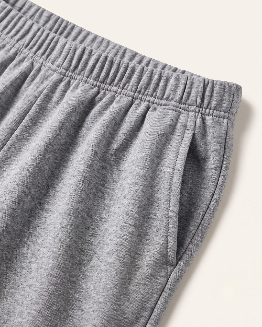Close-up of the elastic waistband on grey marl kids shorts