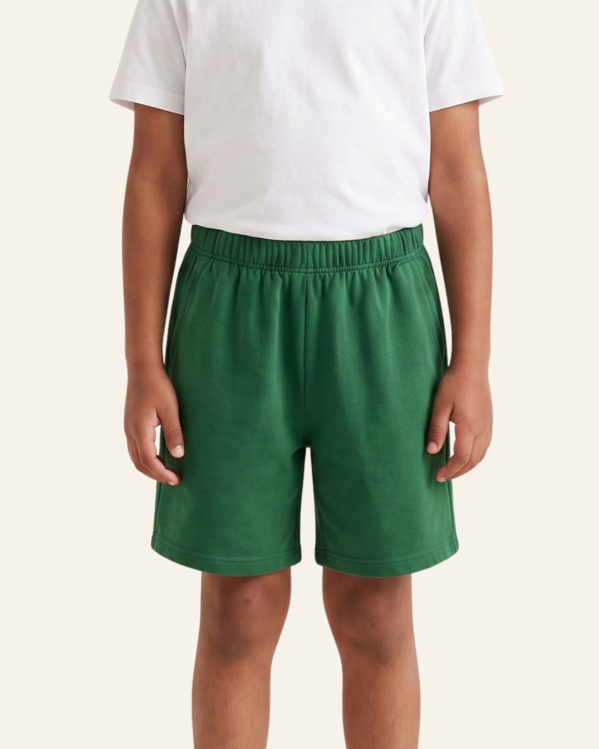 Boy wearing green OUTCAST kids shorts