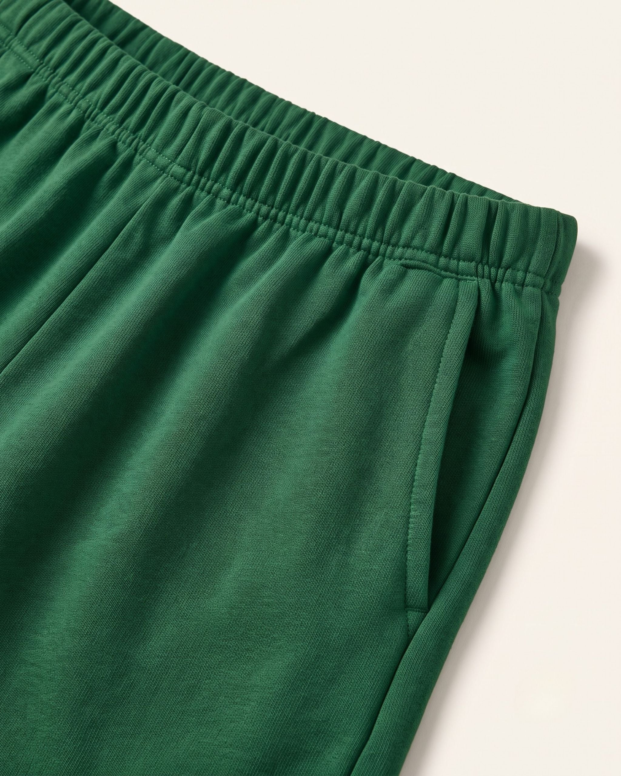 Close-up of the elastic waistband on green kids shorts