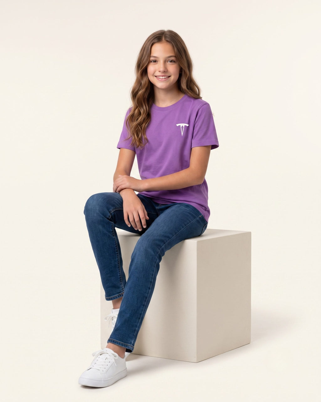Girl sitting wearing a purple OUTCAST basic tee with jeans