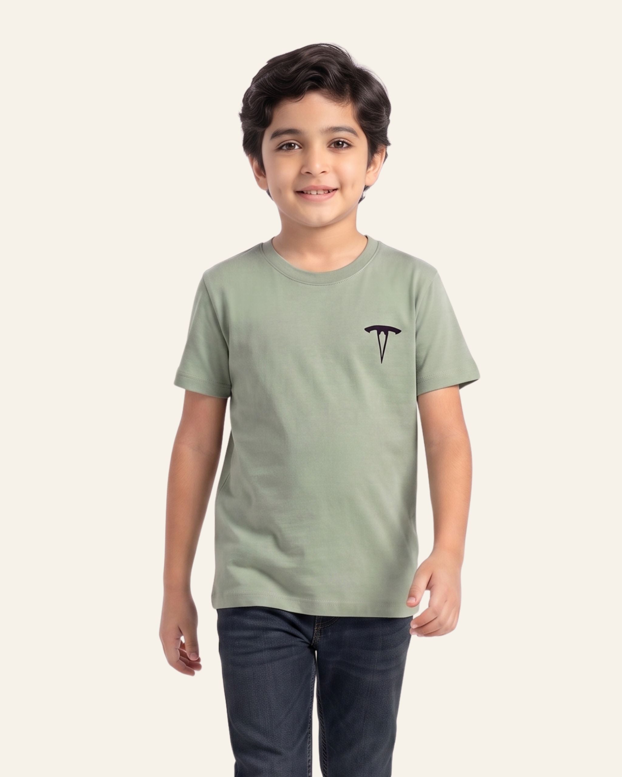 Boy wearing a sage OUTCAST basic tee with jeans