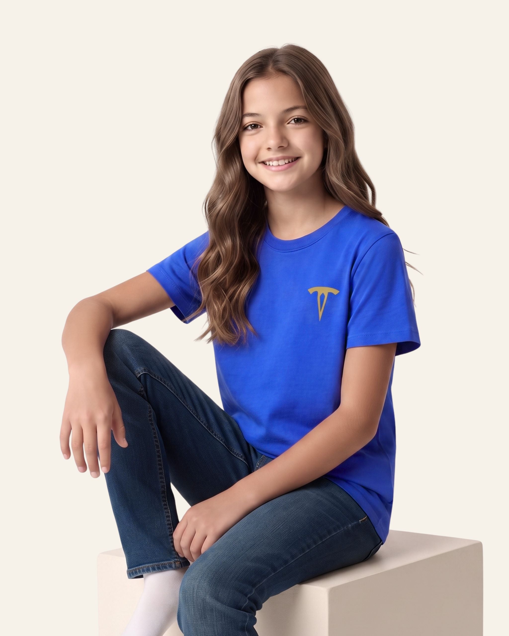 Girl sitting wearing a royal blue OUTCAST basic tee