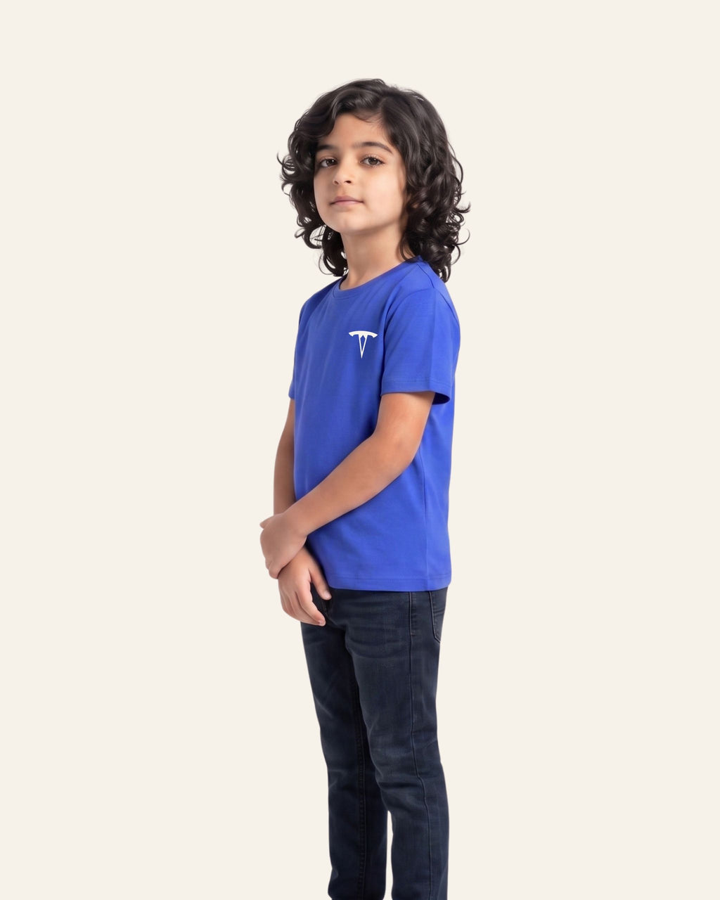 Boy wearing a royal blue OUTCAST basic tee, side view