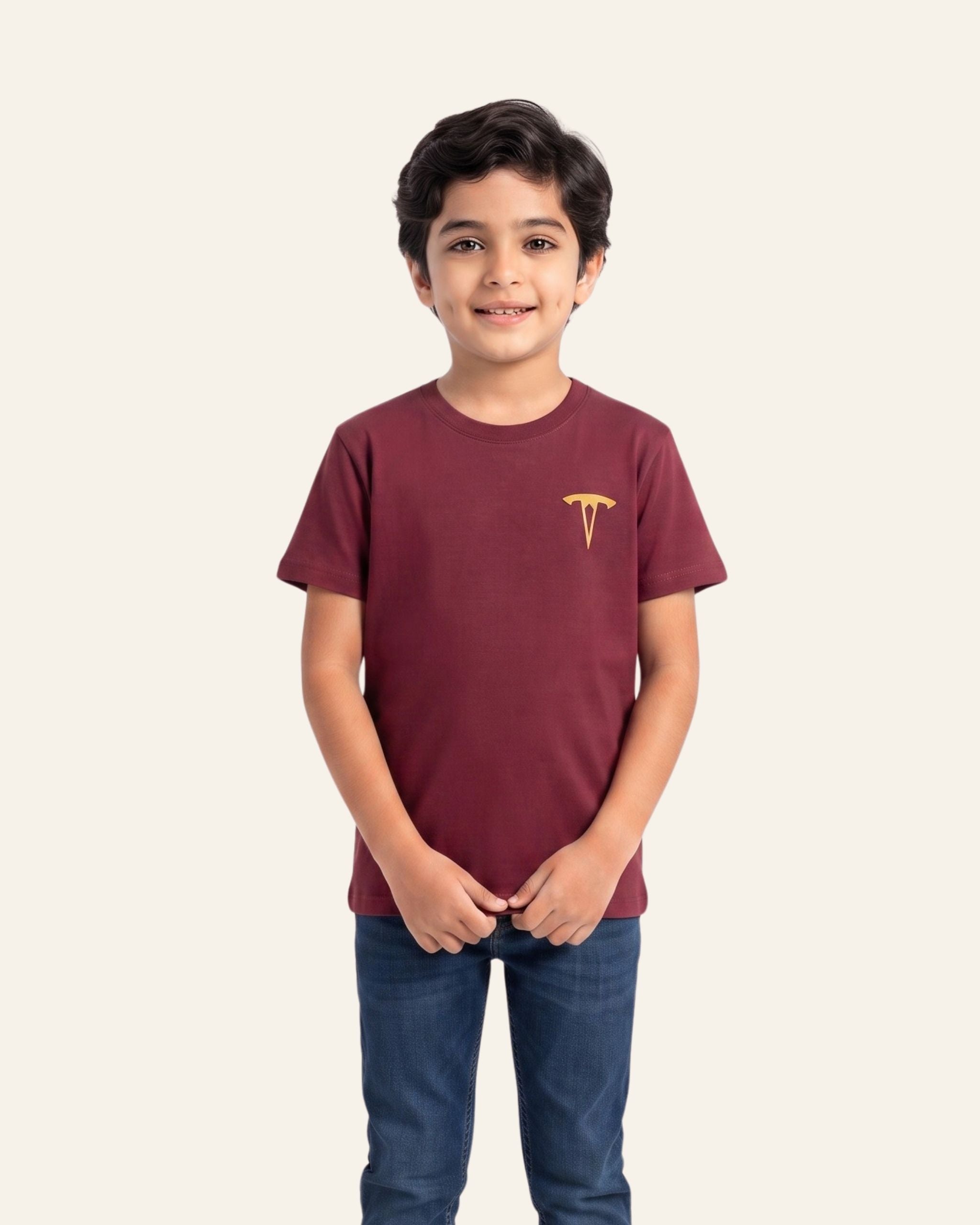 Boy wearing a maroon OUTCAST basic tee with jeans