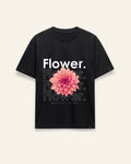 Front of the black cotton tee with a pink dahlia bloom under a clean Flower wordmark