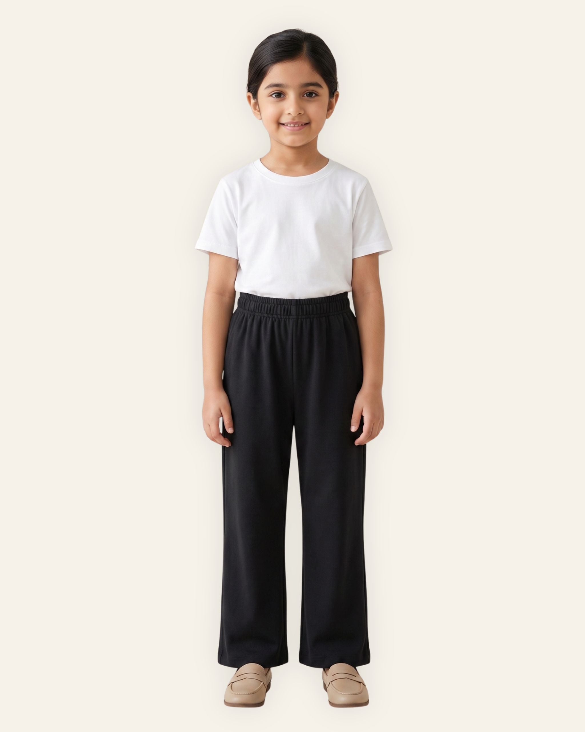 Girl wearing black OUTCAST kids trousers with a white tee