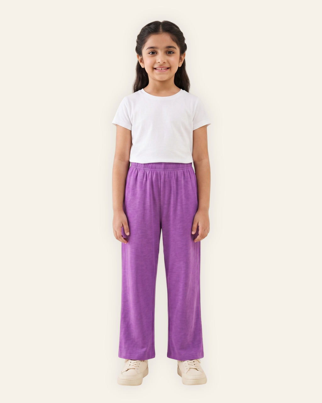 Girl wearing violet OUTCAST kids trousers with a white tee