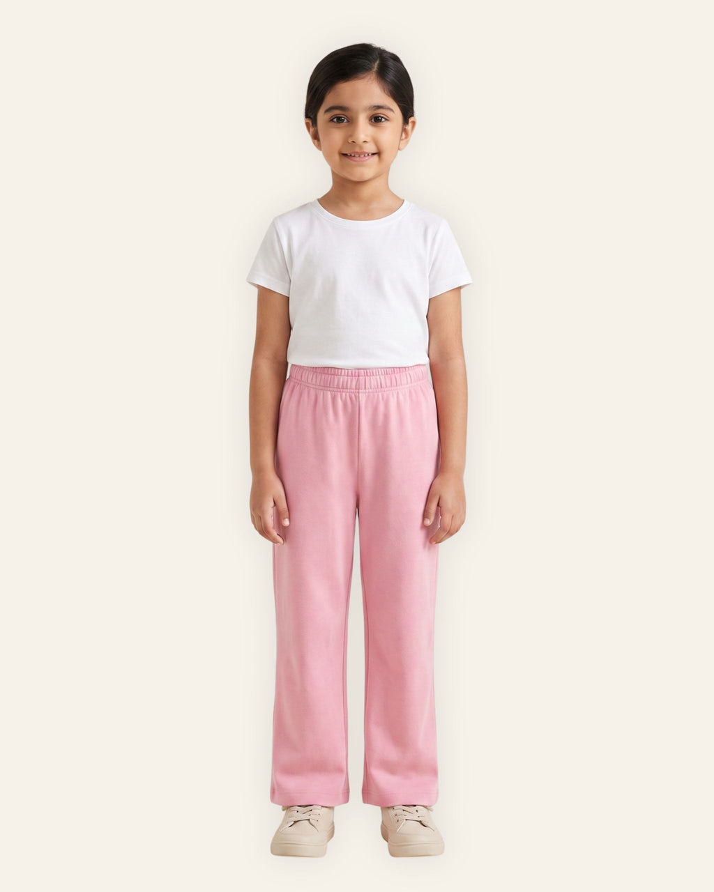 Girl wearing pink OUTCAST kids trousers with a white tee