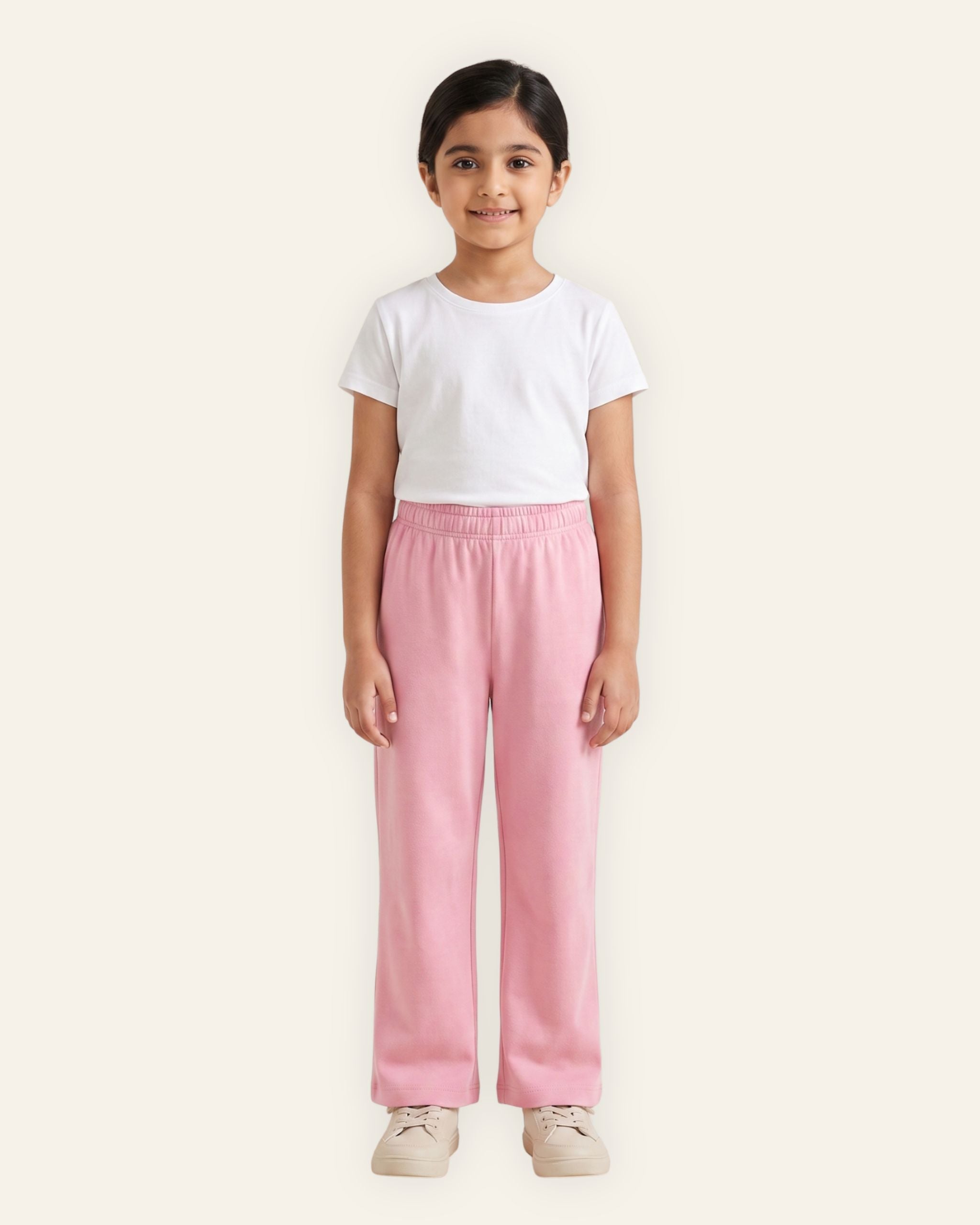 Girl wearing pink OUTCAST kids trousers with a white tee