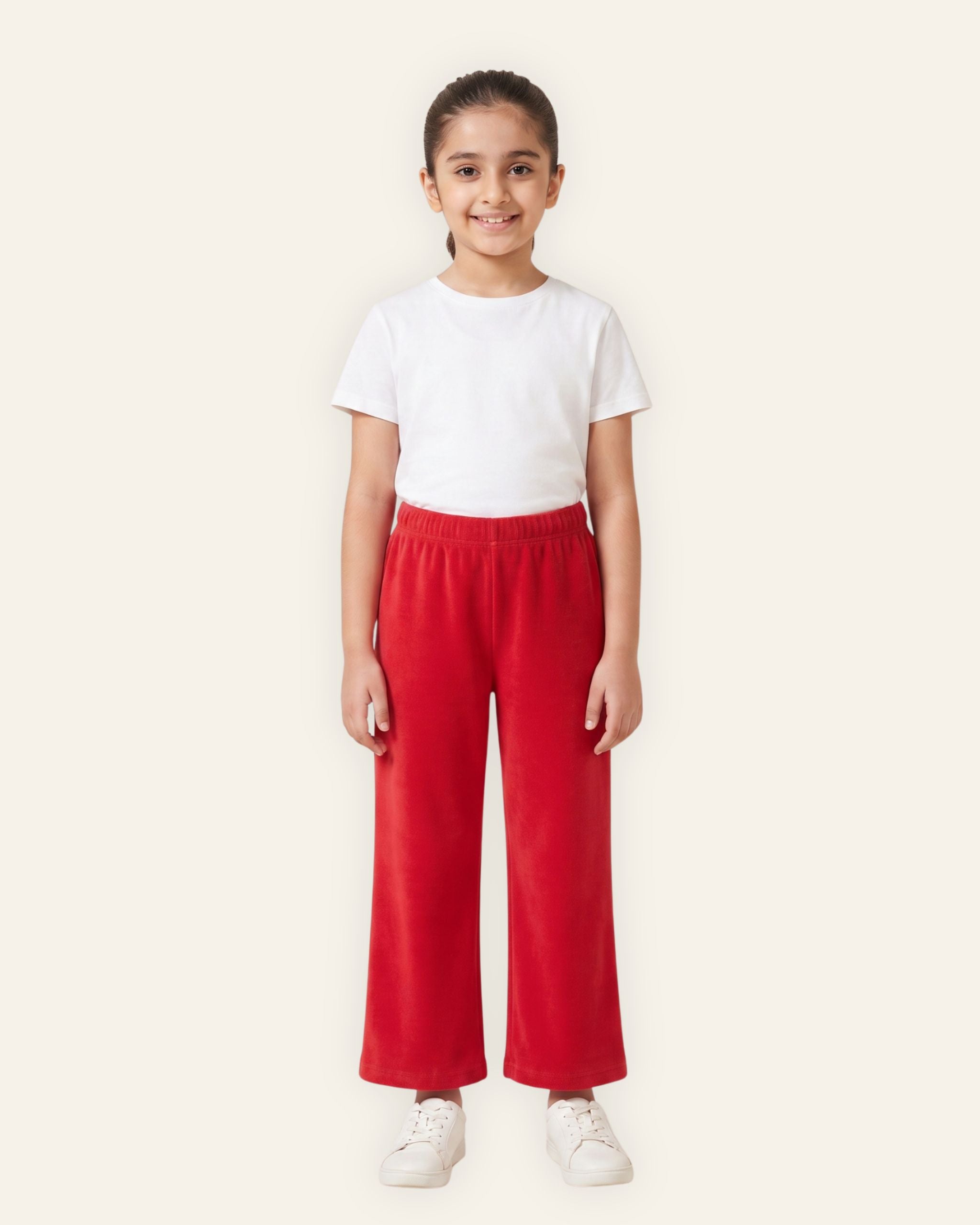 Girl wearing red OUTCAST kids trousers with a white tee