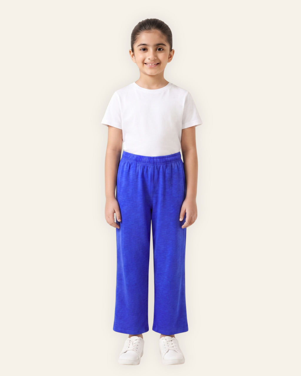 Girl wearing royal blue OUTCAST kids trousers with a white tee