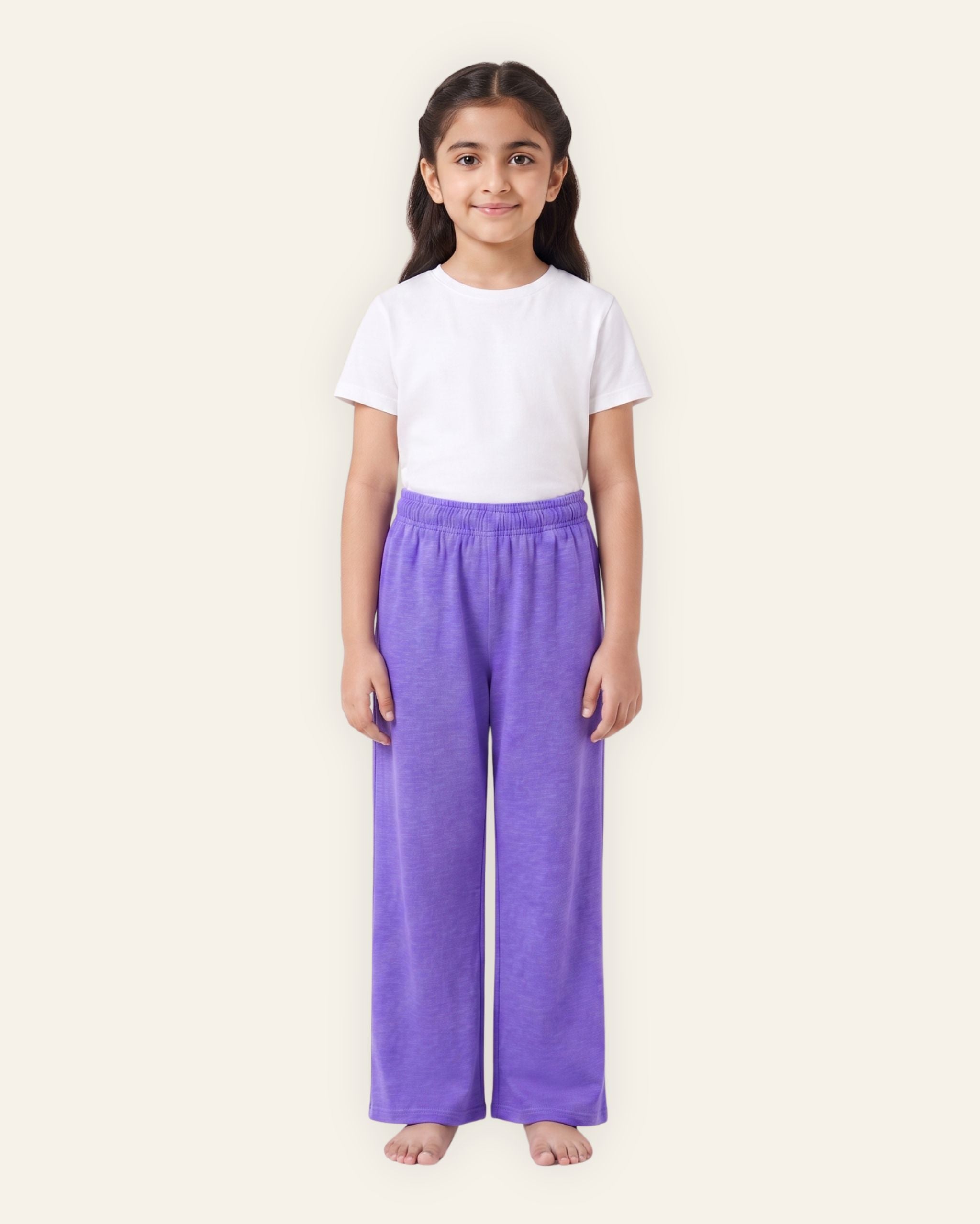 Girl wearing purple OUTCAST kids trousers with a white tee
