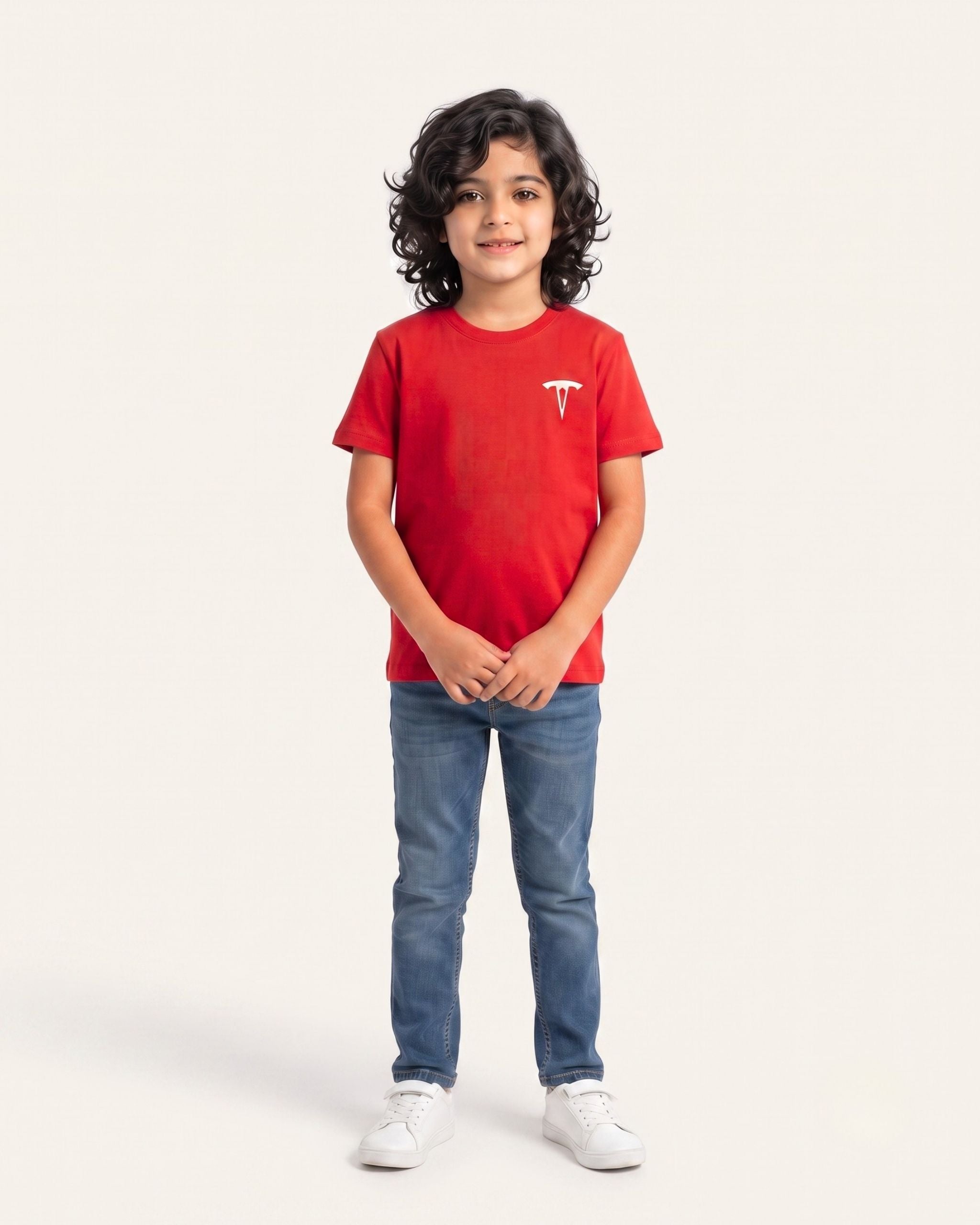 Boy wearing a red OUTCAST basic tee with jeans