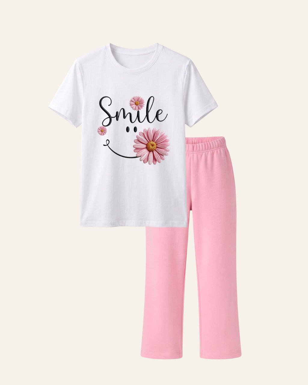 White kids tee with a smiling pink daisy print and matching pink trousers