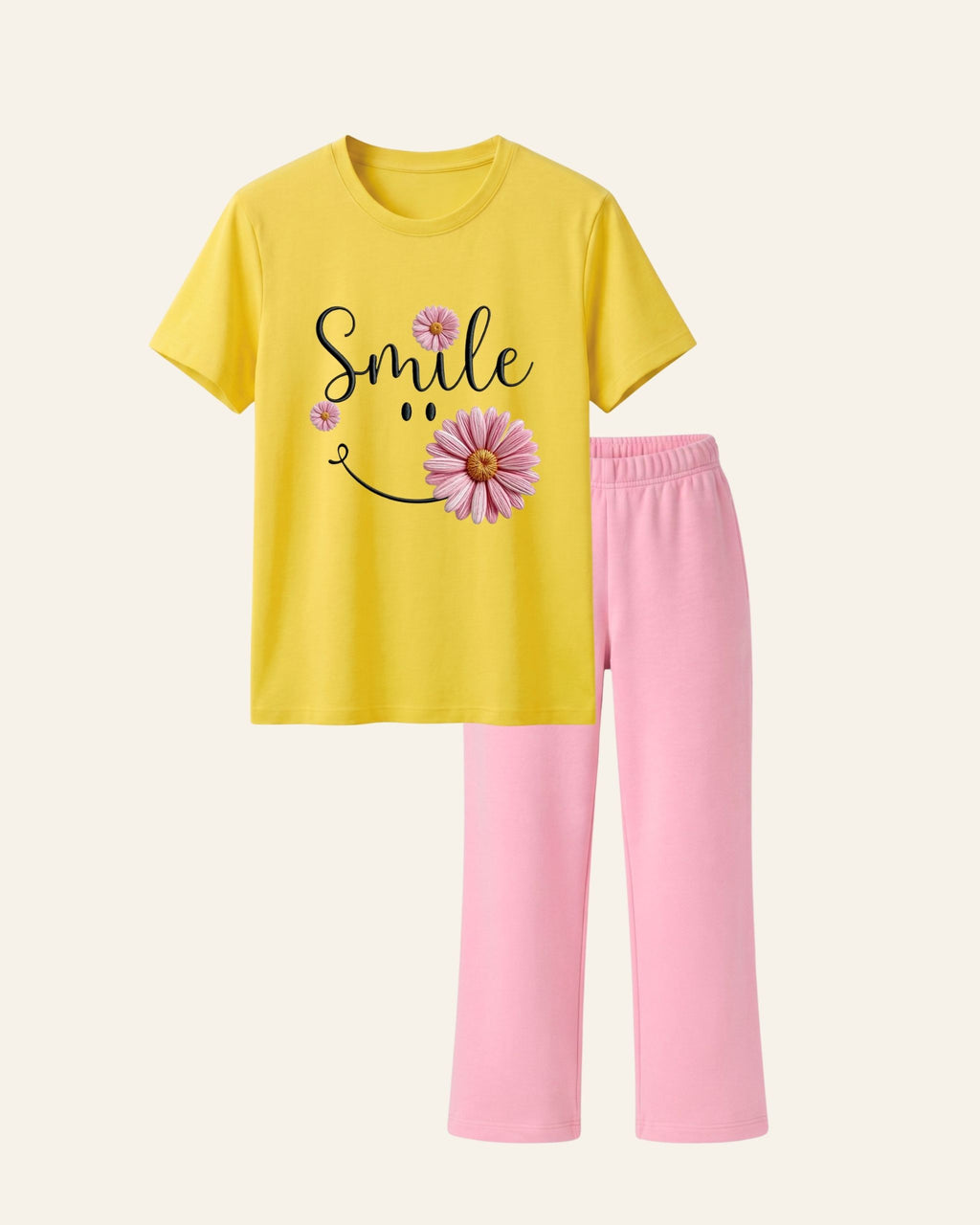 Yellow kids tee with a smiling pink daisy print and matching pink trousers