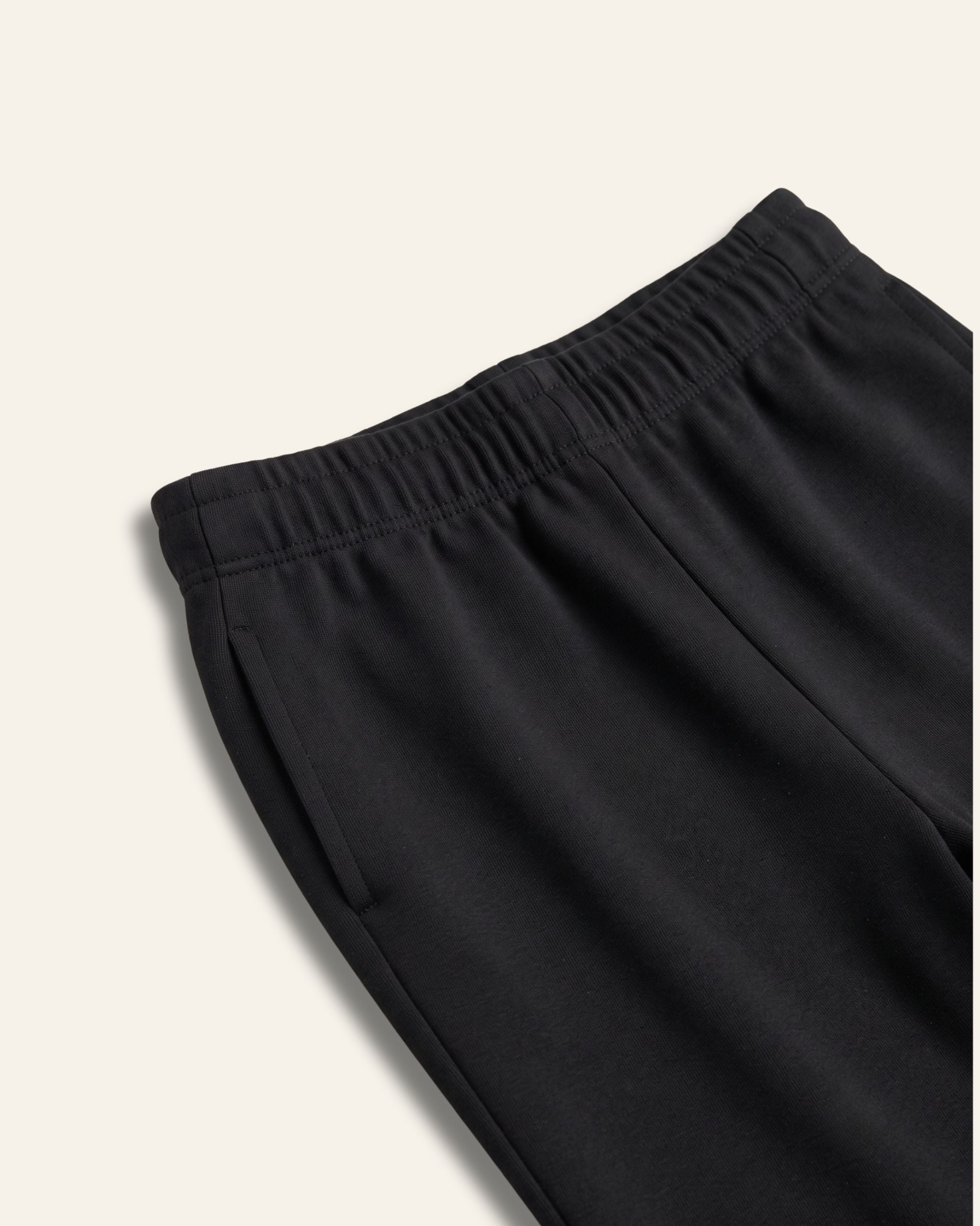 Close-up of the elastic waistband on black kids trousers