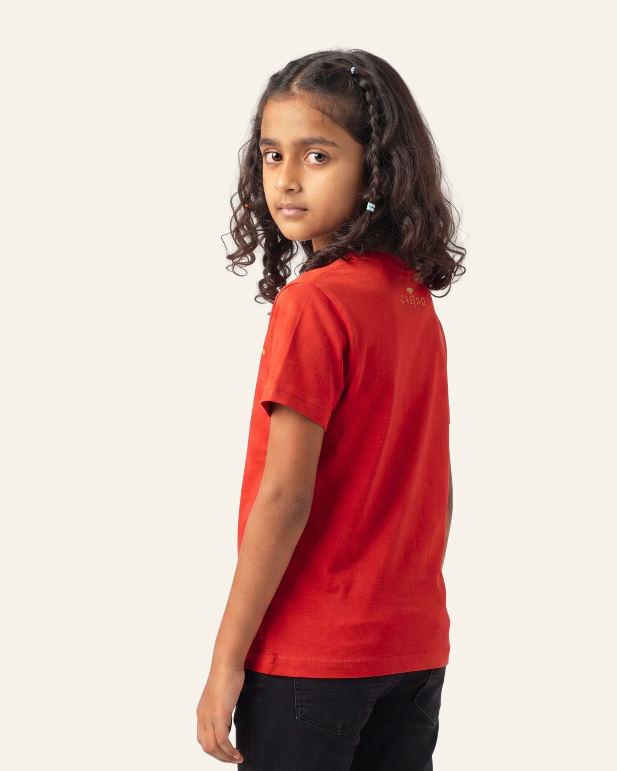 Girl wearing a red OUTCAST basic tee, side view